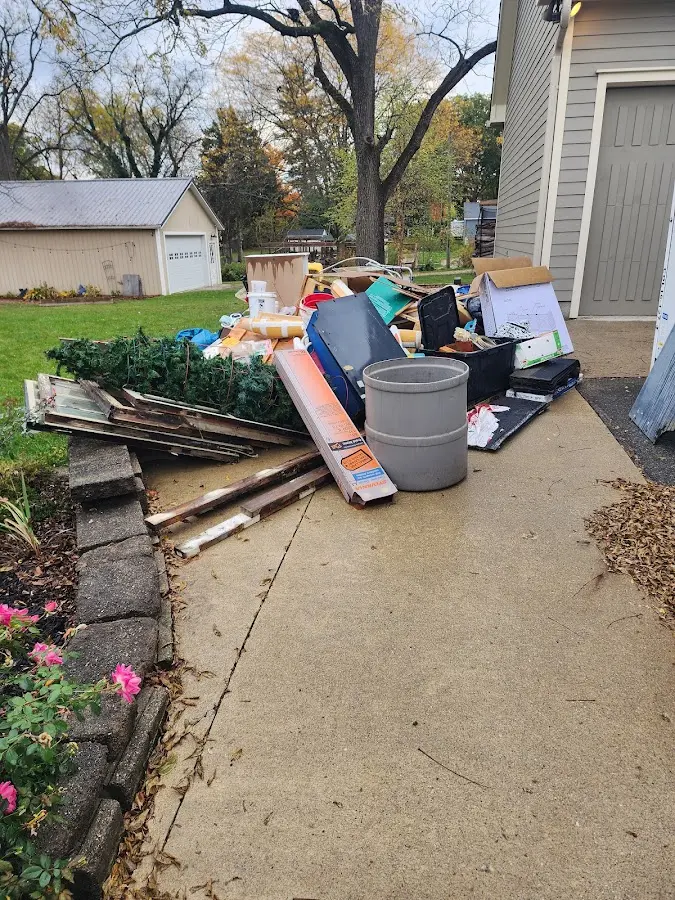 Dumpster being loaded with debris for Demolition Dumpster Rental in Lake City